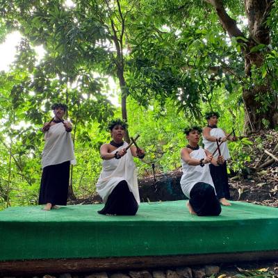 a group of people sitting on a bench in a park