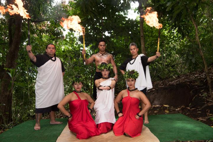 a group of people standing around a fire