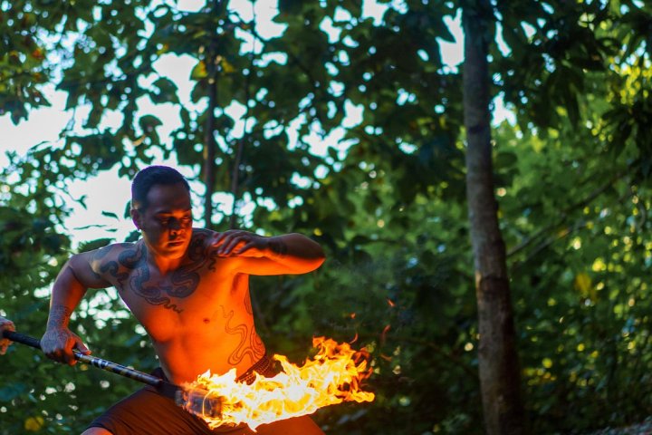 a man holding an orange frisbee
